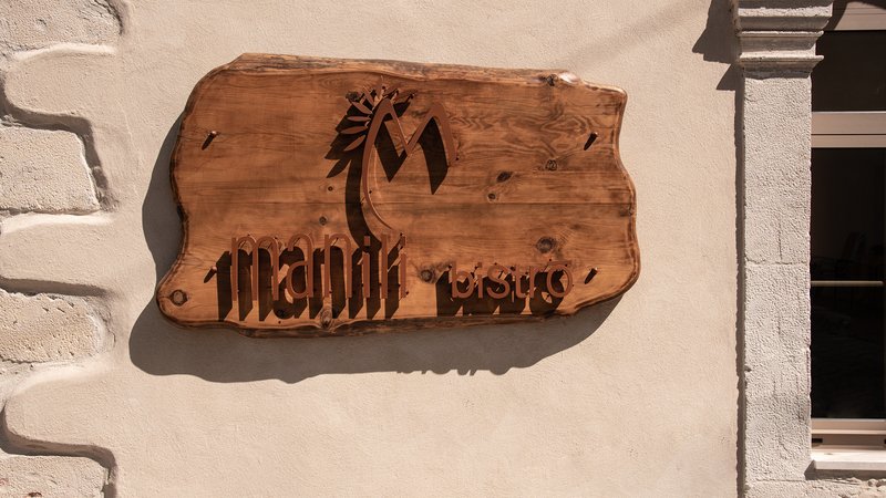 Wooden carved signage of Manili Bistro