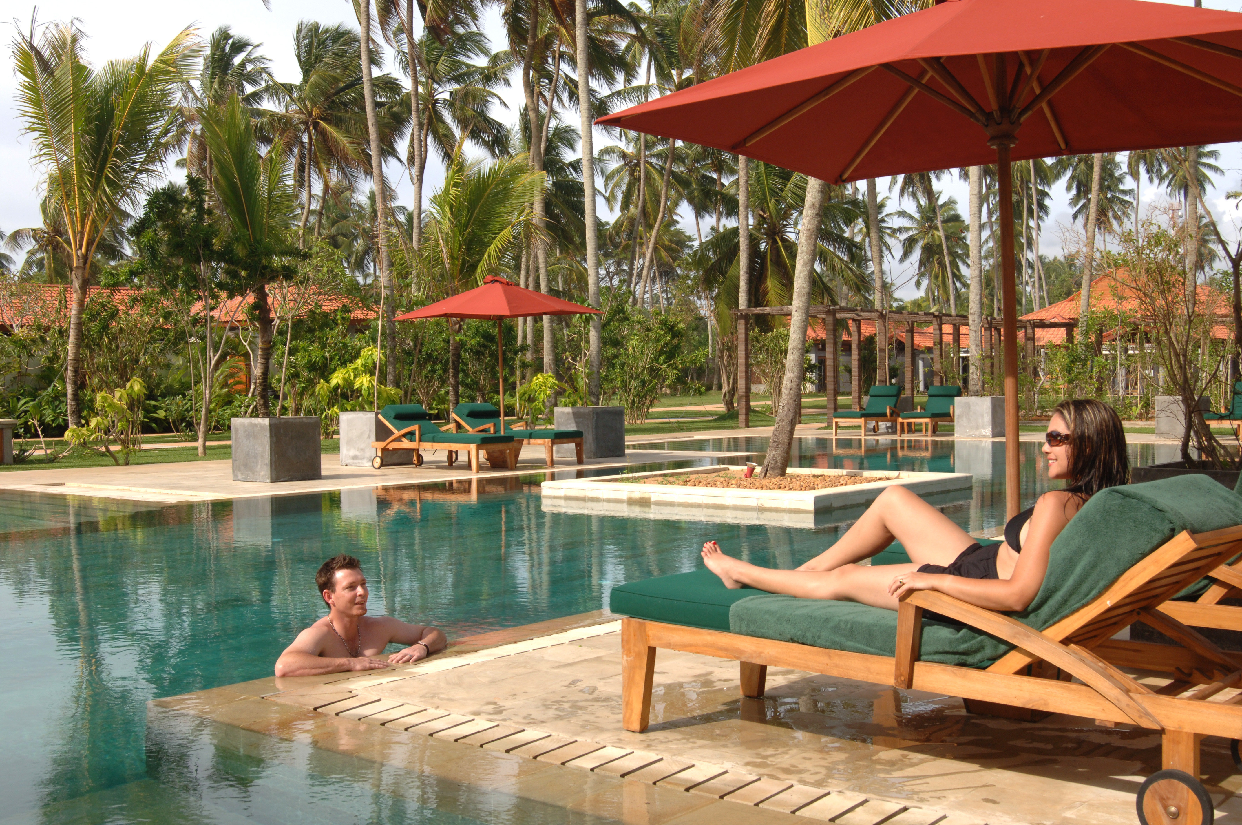 Couple Relaxing by the Swimming Pool