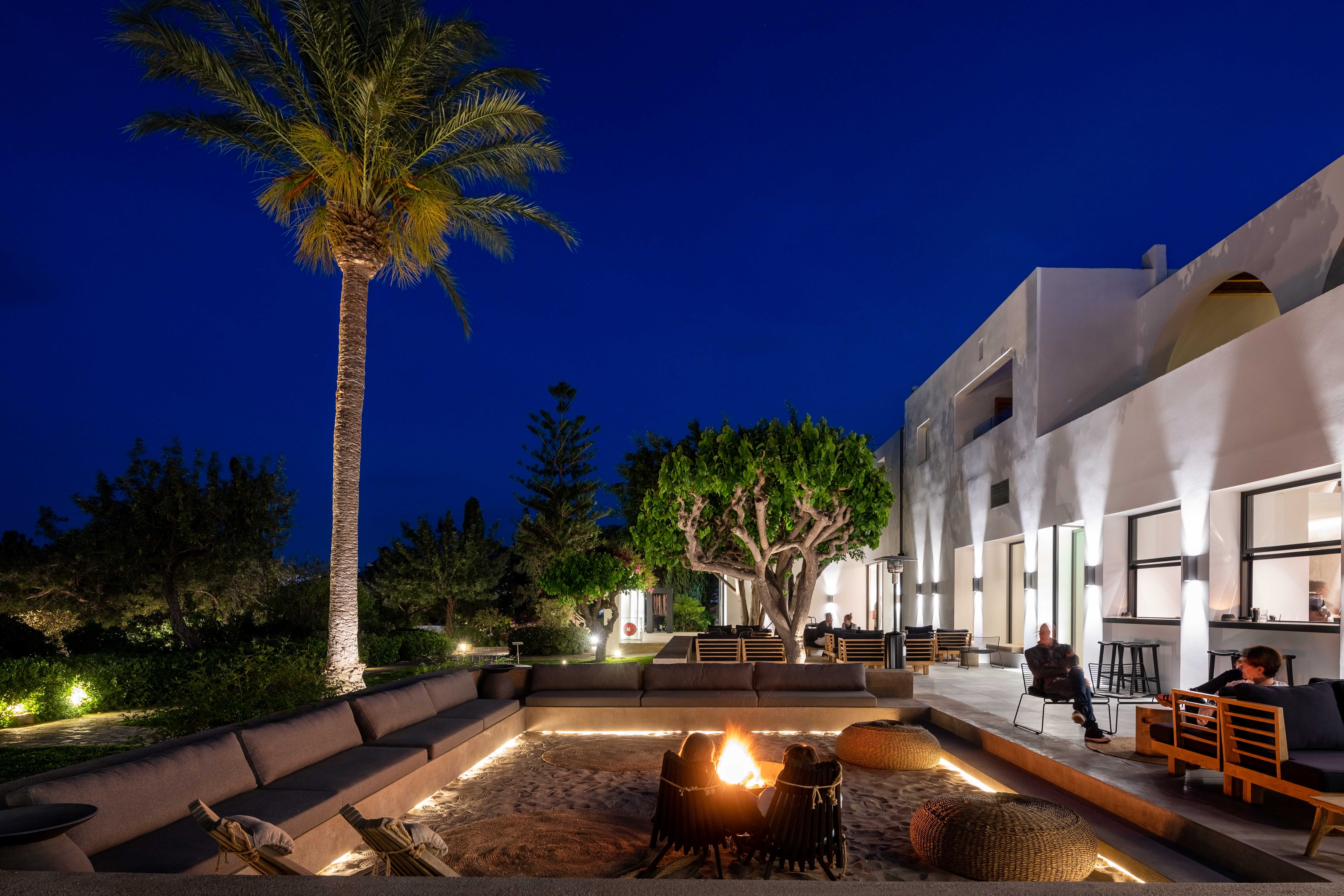 Outdoor Fireplace Area Night Main Bar Minos Beach